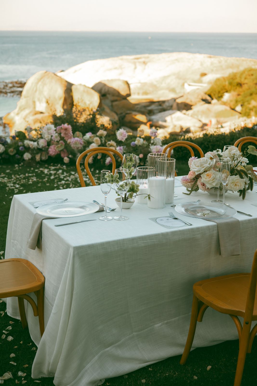 Wedding table with candles and florals overlooking the sea