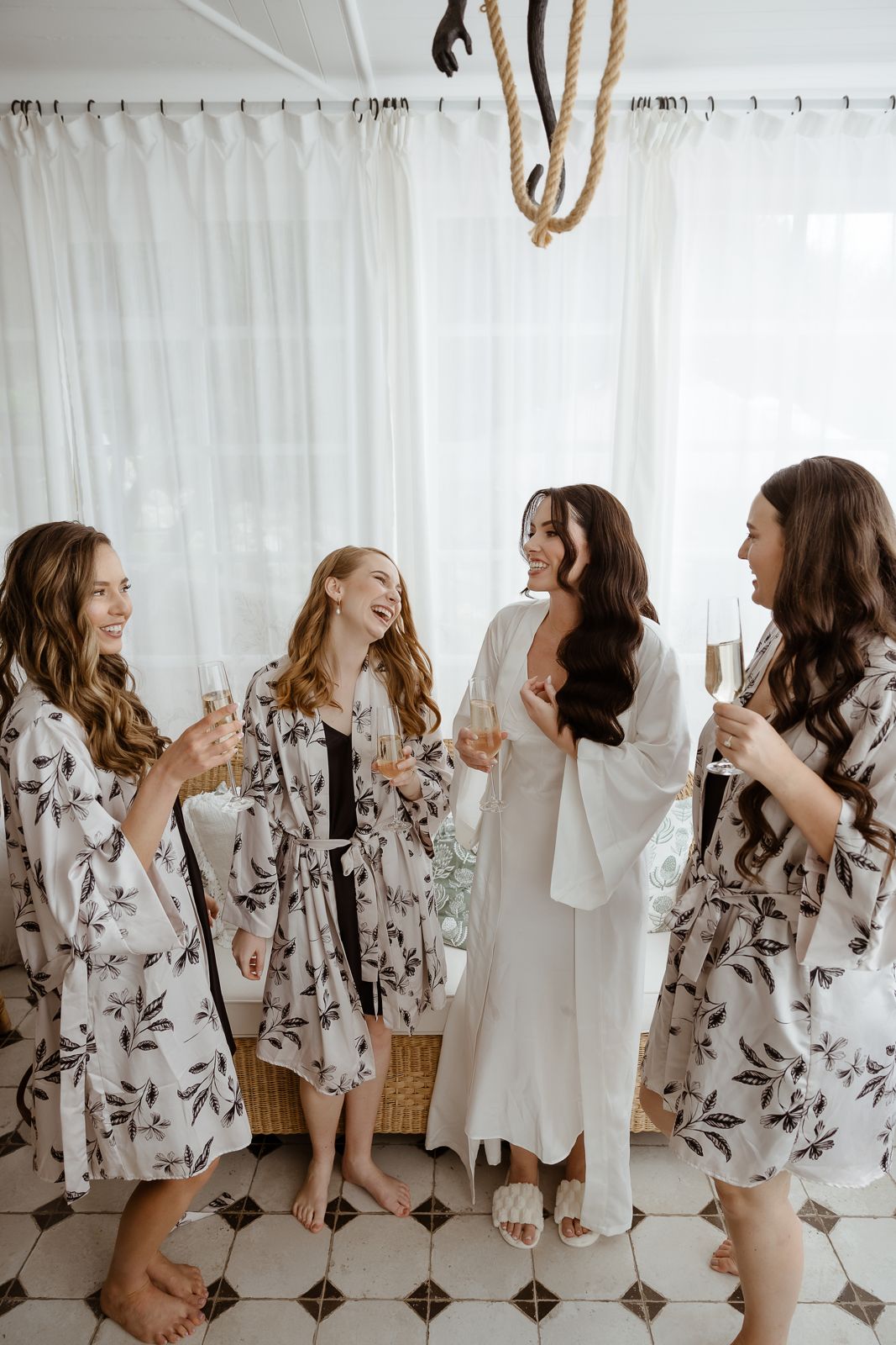 Bride and bridesmaids toasting in floral robes