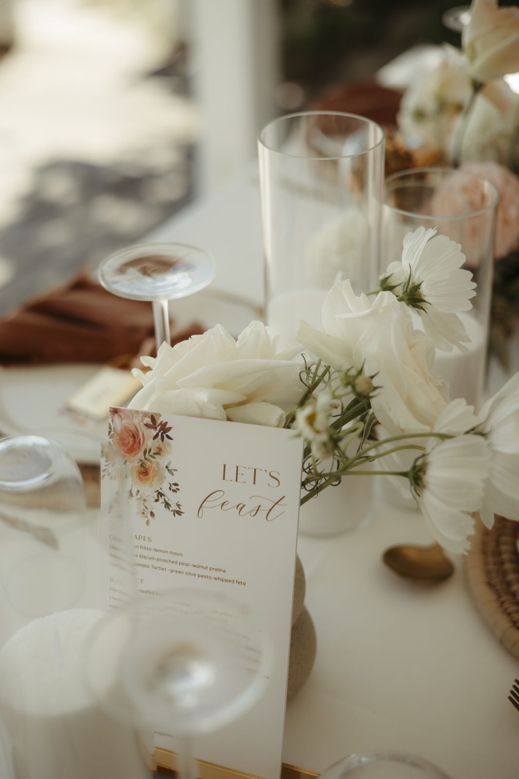 Place setting with white florals and a menu card