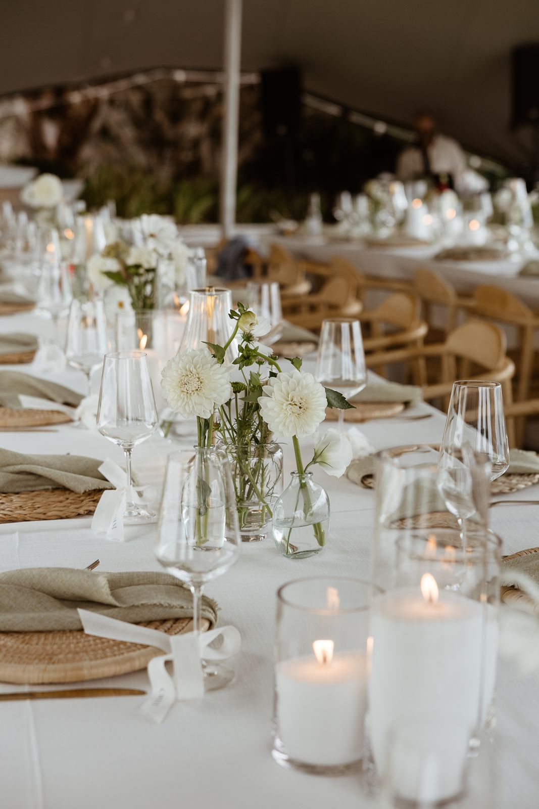 Long reception tables set with candles and glassware