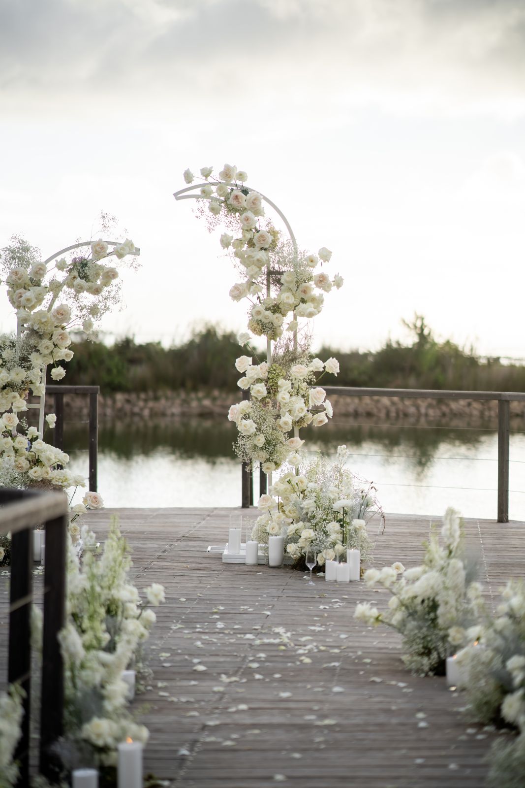 Jetty lined with white florals and floral arches