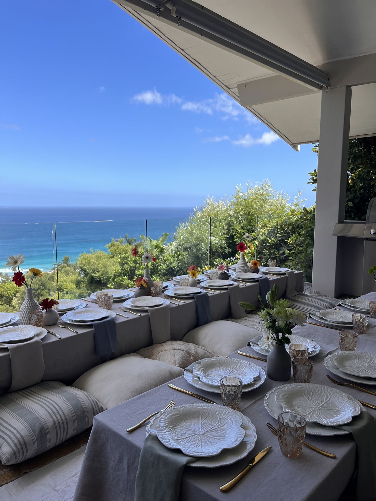 Low dining table on a terrace above the sea