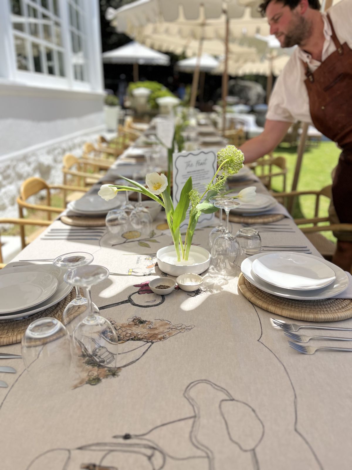 Long table being set for a garden lunch
