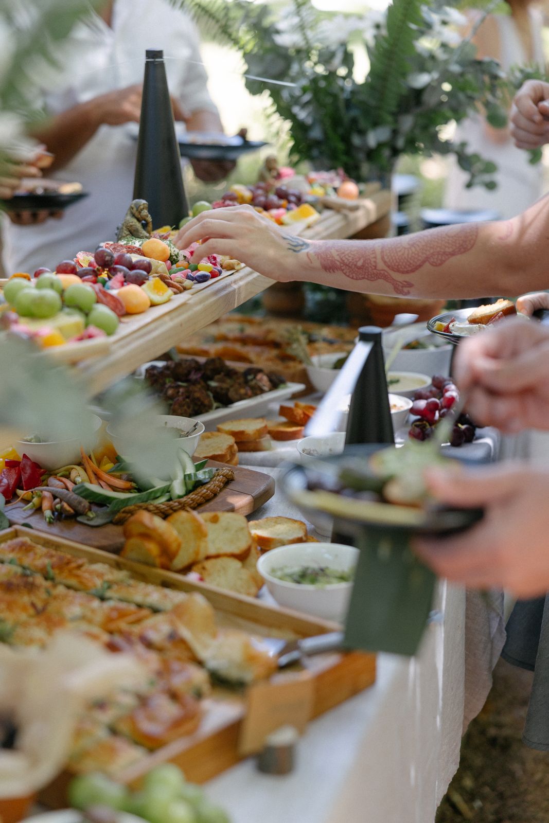 Grazing table piled with fruit, breads and charcuterie