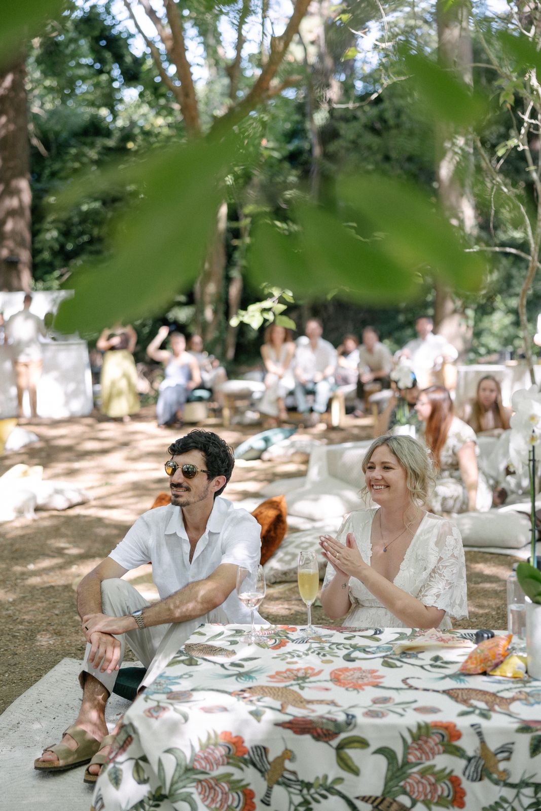 Couple at a floral-cloth low table in the garden
