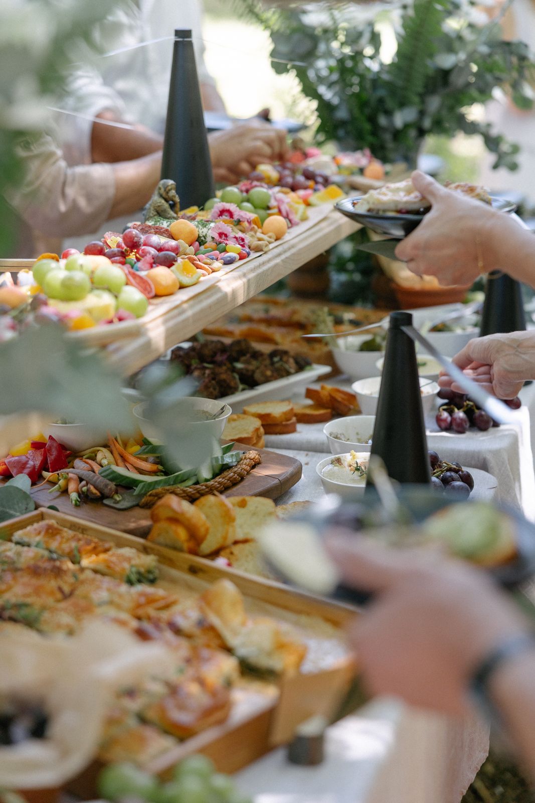Guests serving themselves from a long grazing table