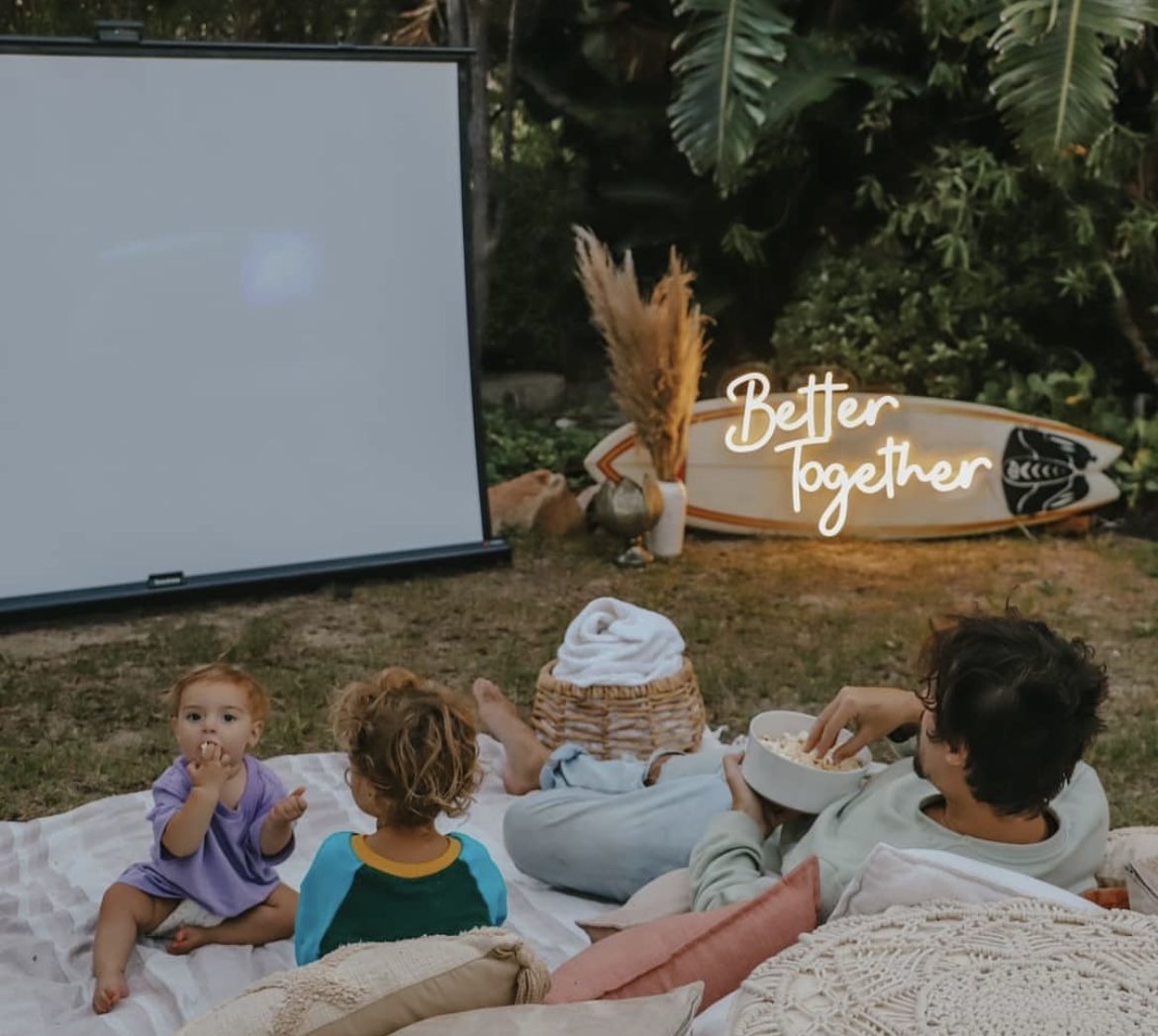 Family with popcorn at a garden film night