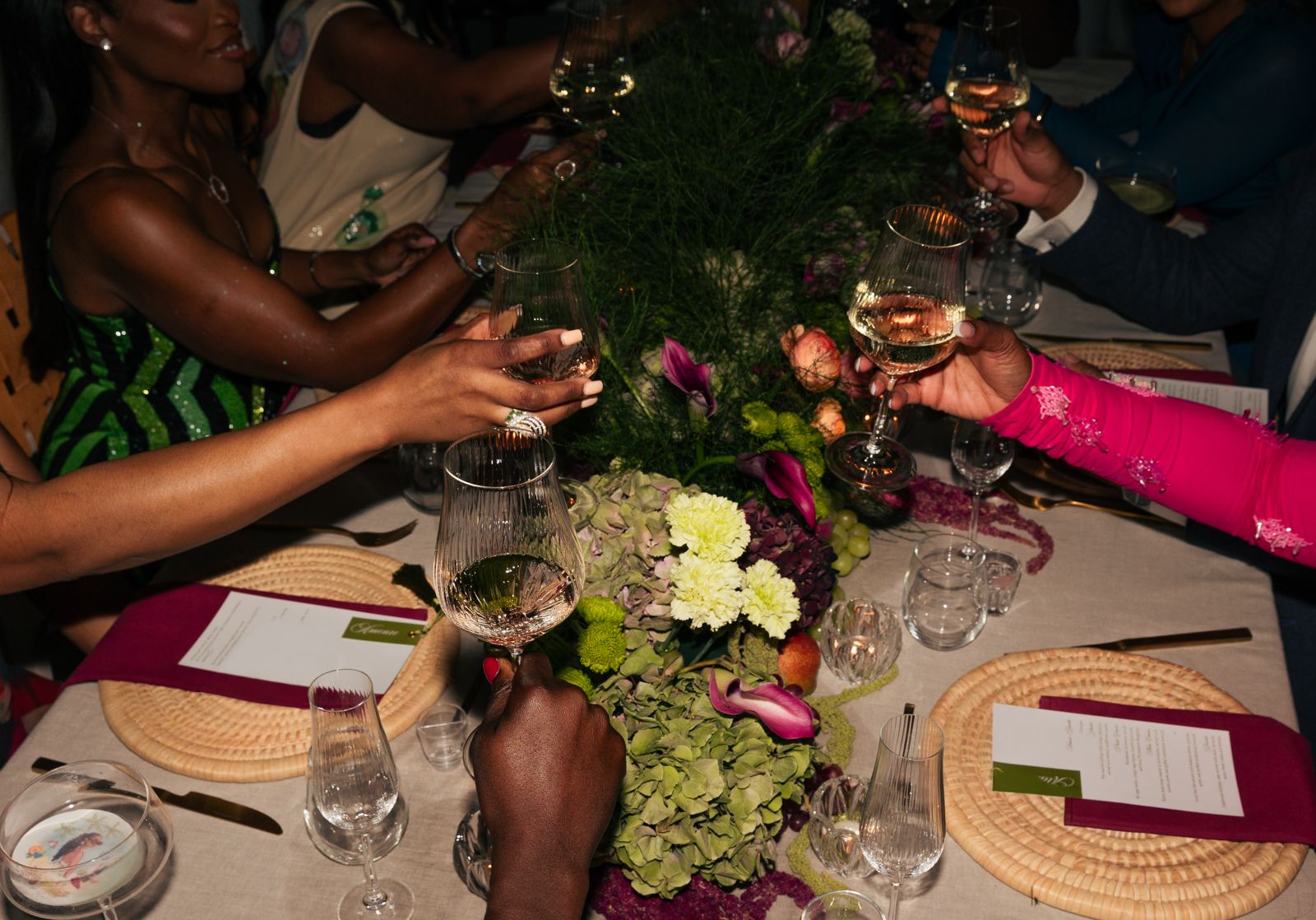 Guests raising a toast over a styled dinner table