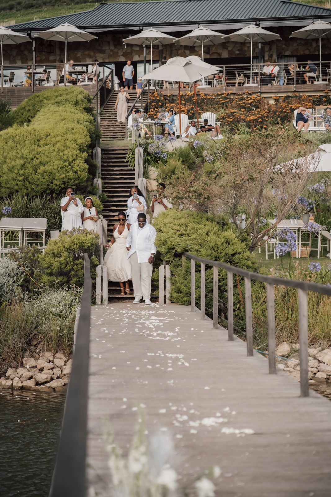 Couple walking down a jetty from a restaurant