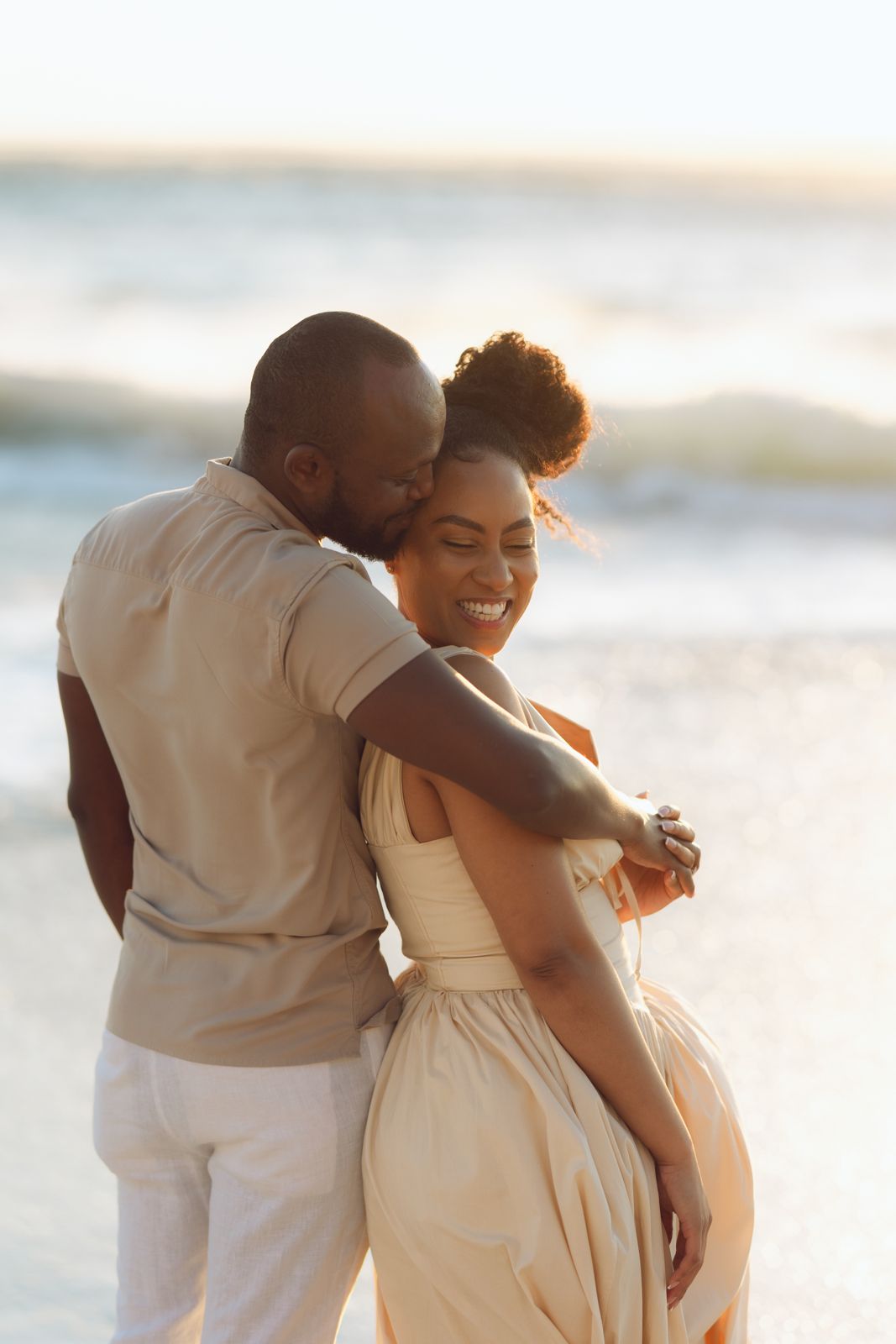 Couple embracing on the beach at sunset