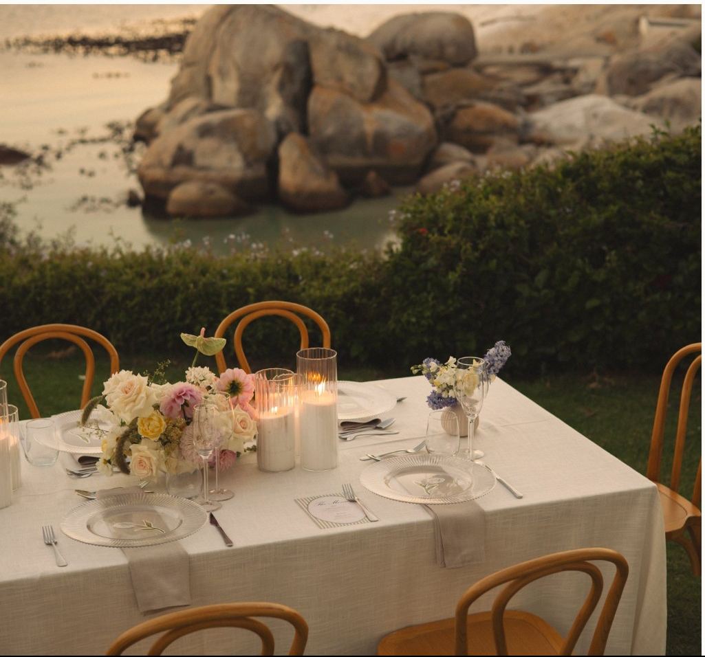 Reception table beside granite boulders by the sea